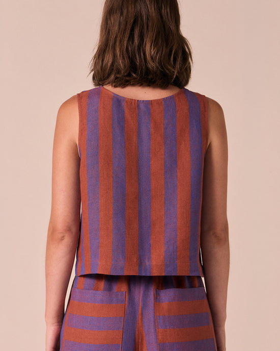 model wears esme terracotta stripe linen top