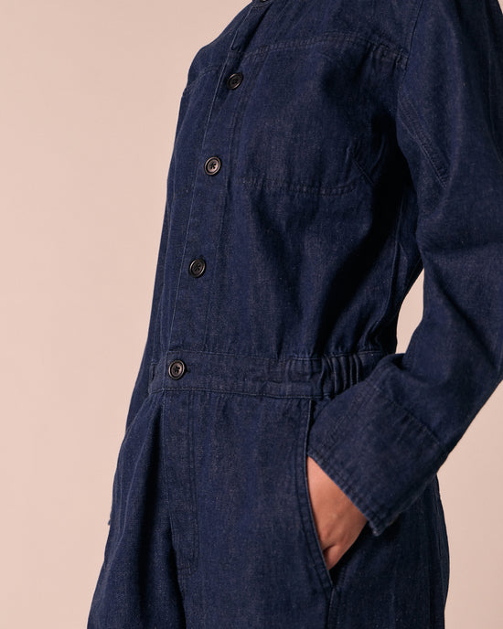 model wears jill dark wash denim jumpsuit