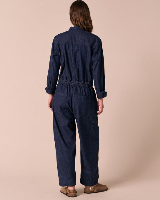 model wears jill dark wash denim jumpsuit