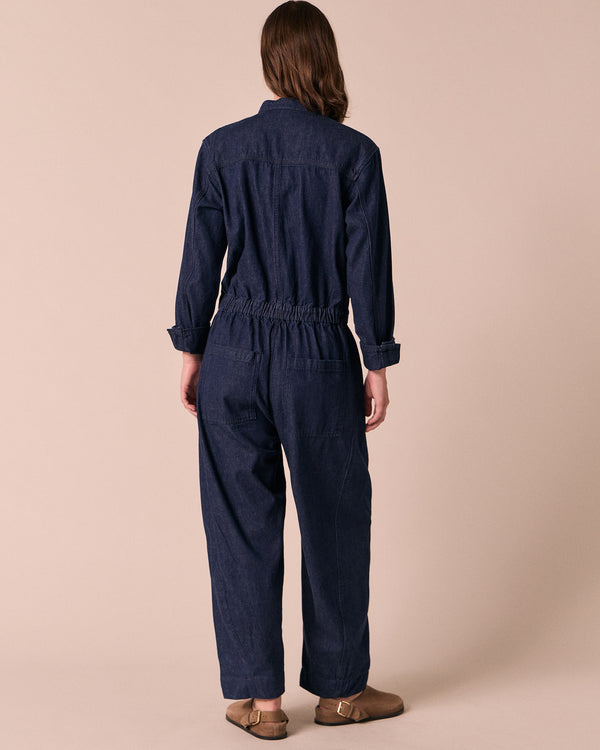 model wears jill dark wash denim jumpsuit