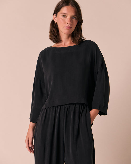 model wears lily black cupro top