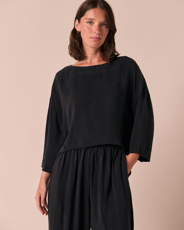 model wears lily black cupro top
