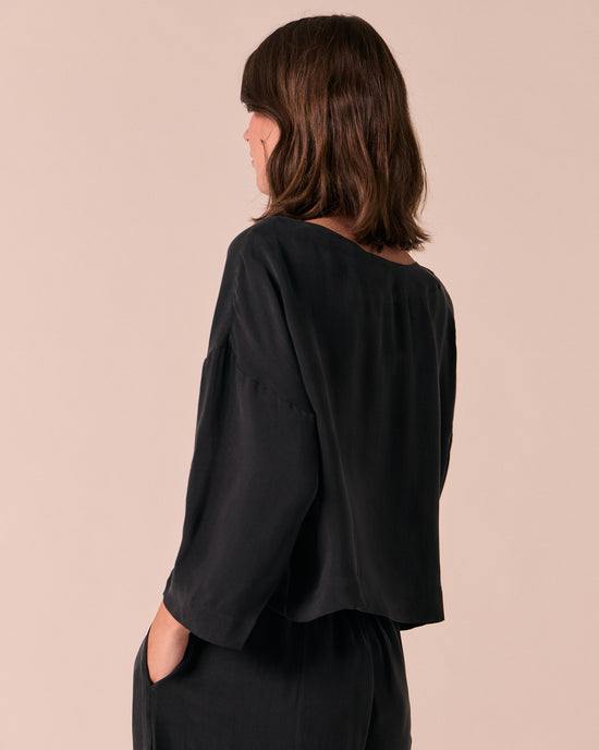 model wears lily black cupro top