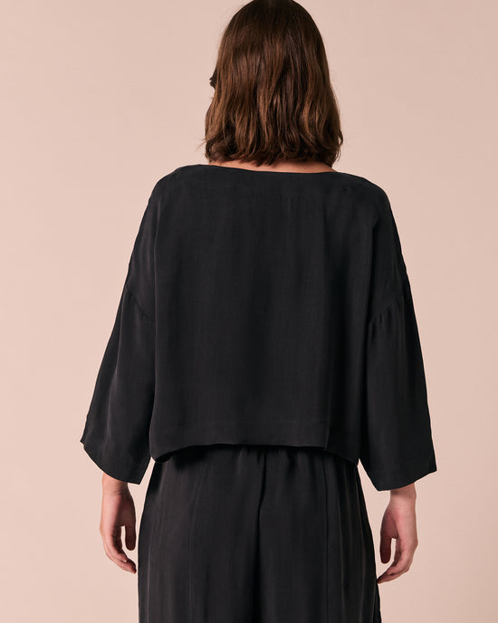 model wears lily black cupro top