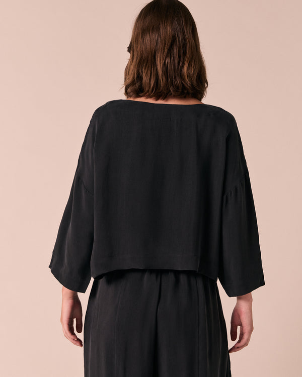 model wears lily black cupro top