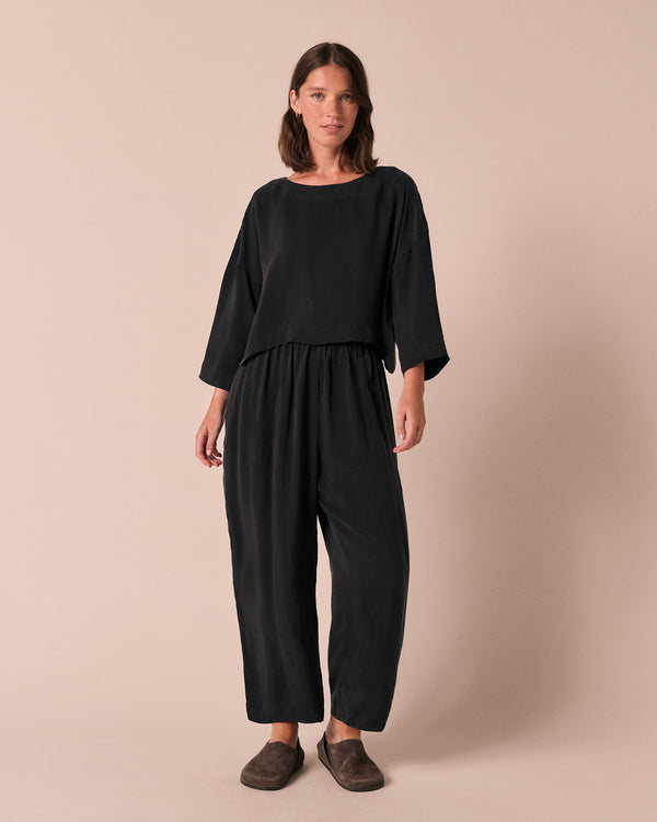 model wears lily black cupro top