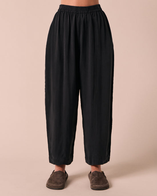 model wears mabel black cupro trousers front