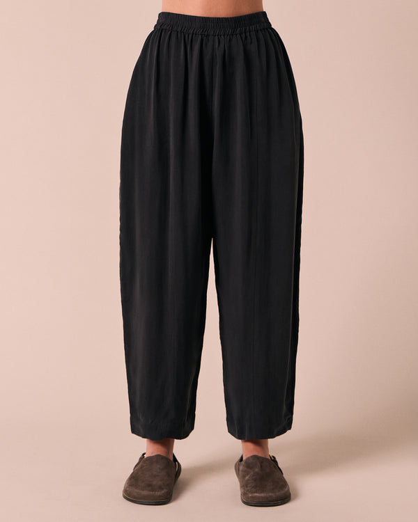 model wears mabel black cupro trousers front