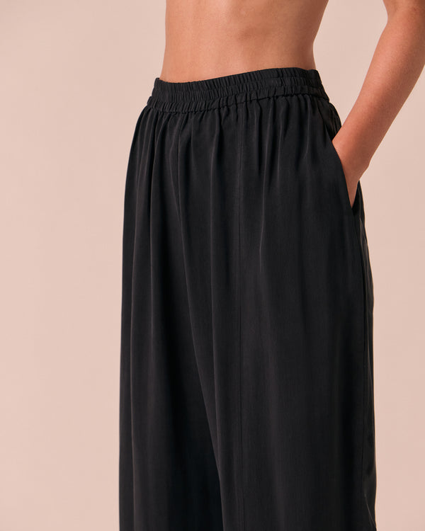 model wears mabel black cupro trousers