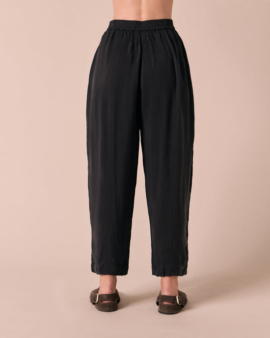 model wears mabel black cupro trousers back