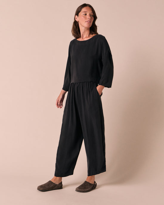 model wears mabel black cupro trousers right