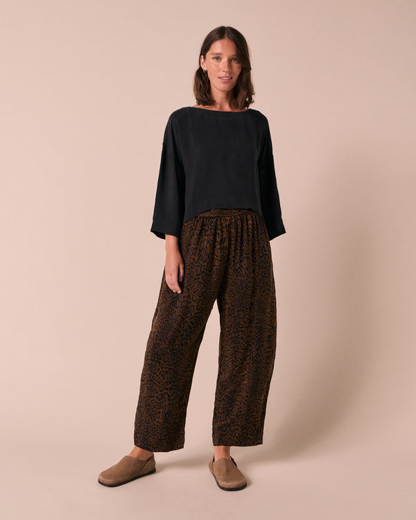 model wears mabel dark leopard cupro trousers right