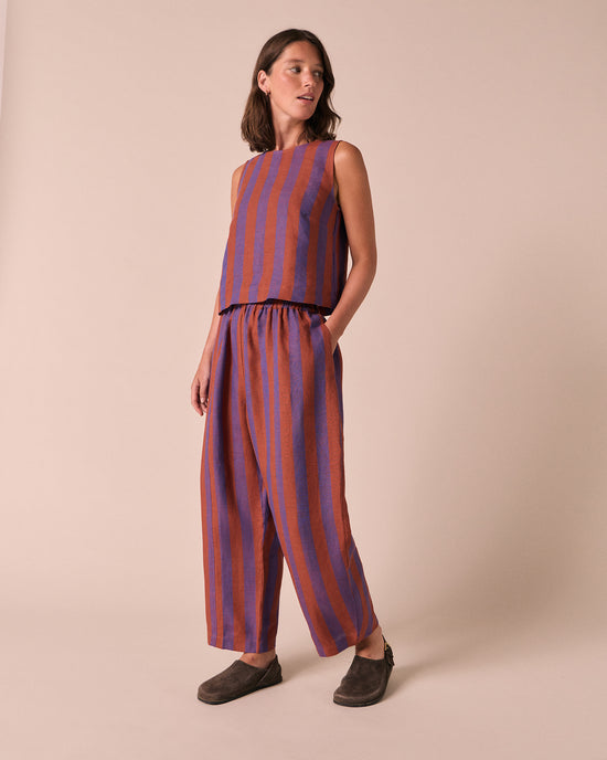 model wears mabel terracotta stripe linen trousers right