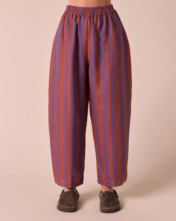 model wears mabel terracotta stripe linen trousers front