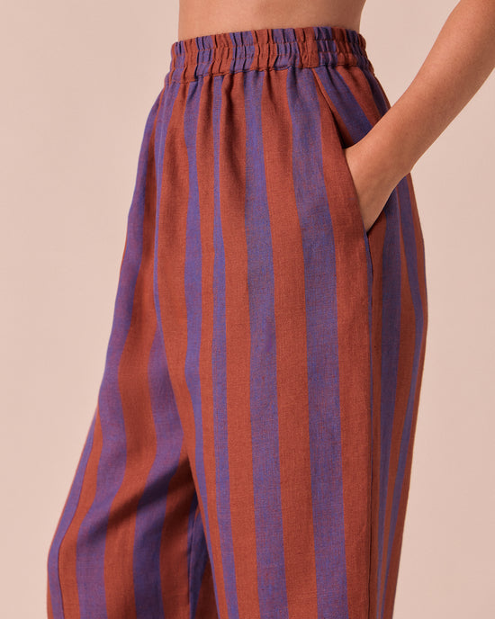 model wears mabel terracotta stripe linen trousers