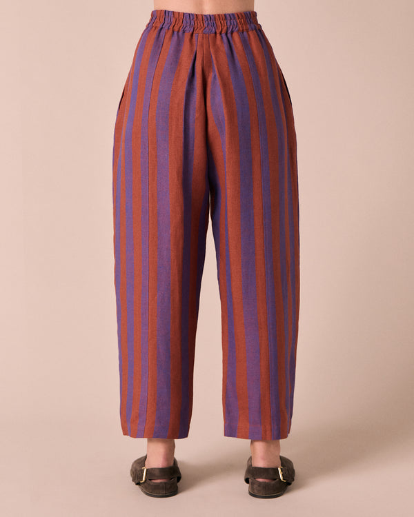 model wears mabel terracotta stripe linen trousers back