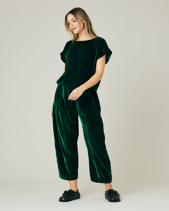 pregnant model wears green velvet polly top and mabel trousers