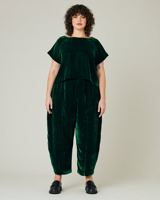 model wears green velvet polly top and mabel trousers