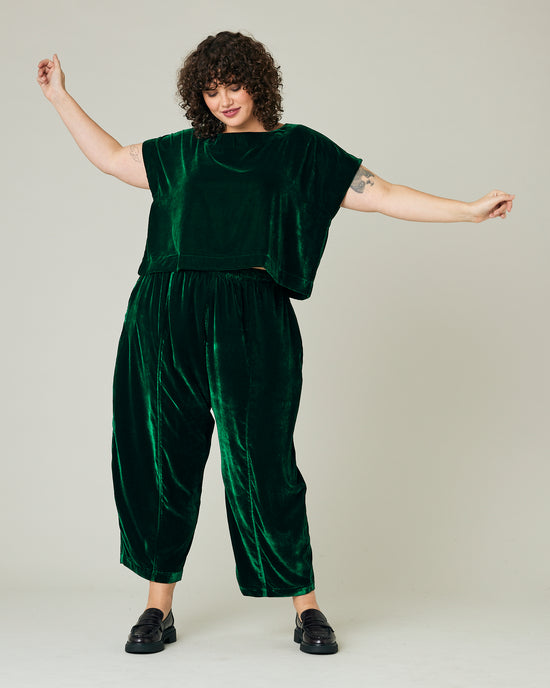 model wears green velvet polly top and mabel trousers