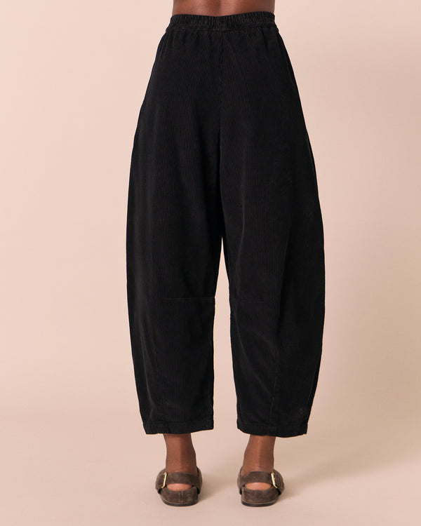 model wears daisy black cord trousers back