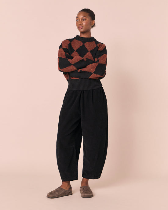 model wears daisy black cord trousers right