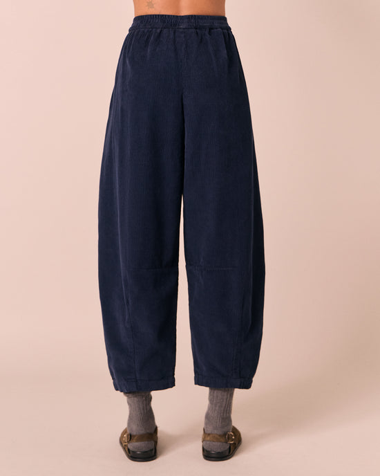 model wears daisy navy cord trousers back