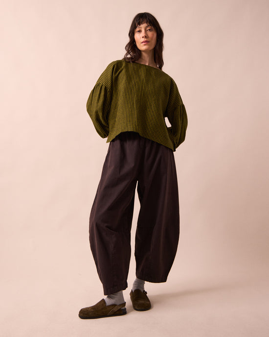 model wears daisy ganache textured cotton trousers right