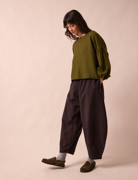 model wears daisy ganache textured cotton trousers left