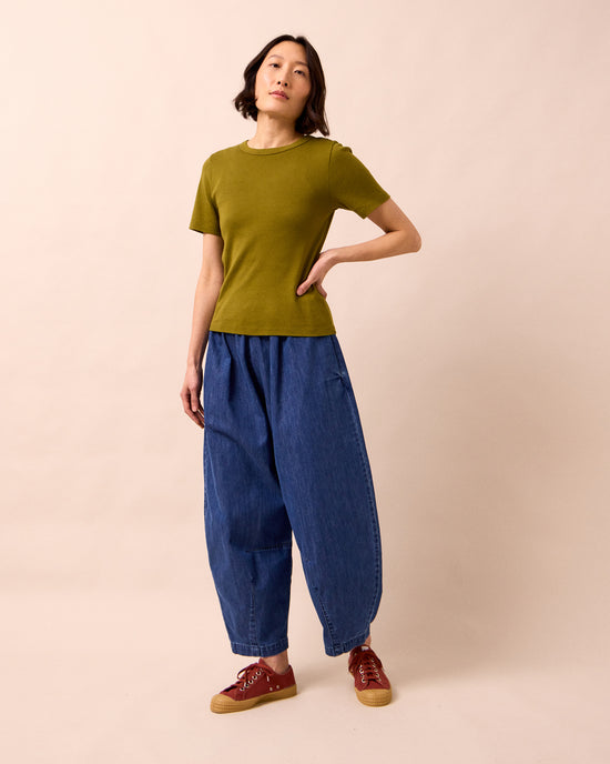 model wears daisy mid blue light weight denim trousers right