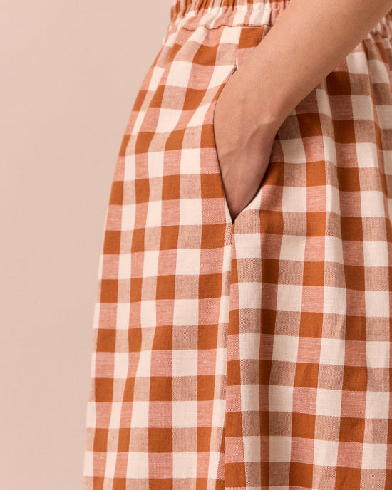 model wears daisy amber check cotton linen trousers