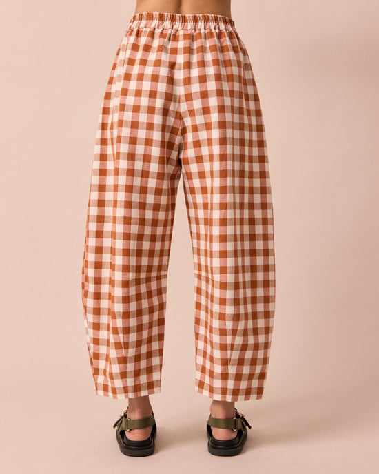 model wears daisy amber check cotton linen trousers back