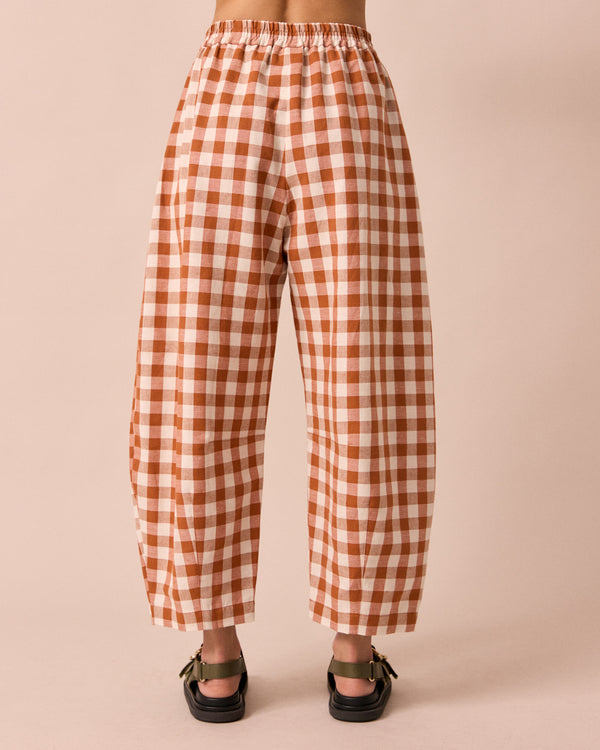 model wears daisy amber check cotton linen trousers back