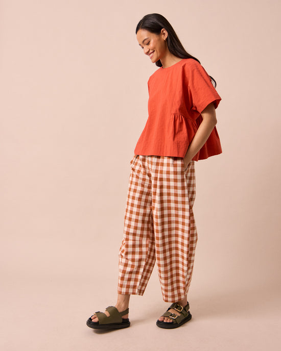 model wears daisy amber check cotton linen trousers right
