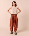 model wears daisy beachcomber print linen trousers.