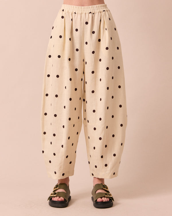 model wears daisy bone spot linen trousers front