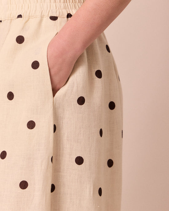 model wears daisy bone spot linen trousers 