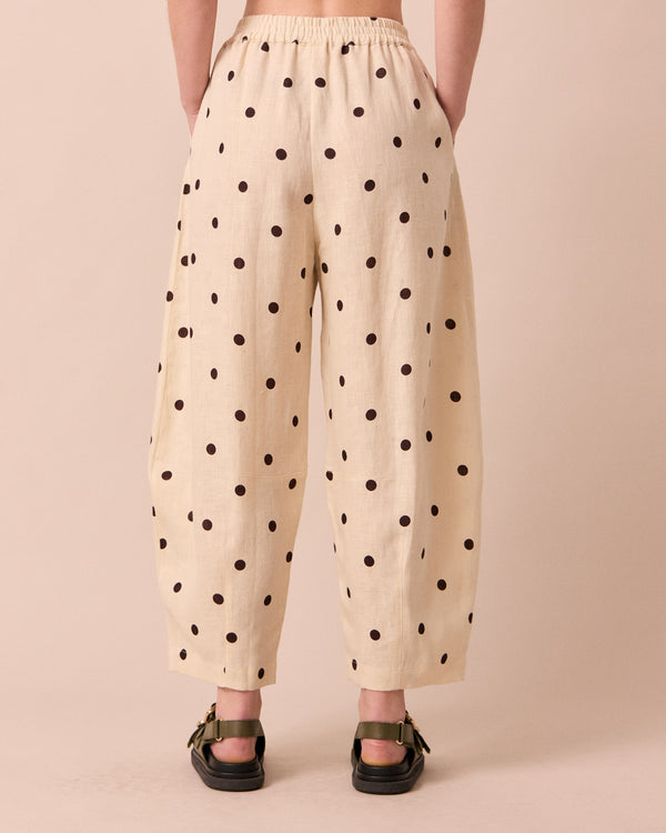 model wears daisy bone spot linen trousers back