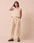 model wears daisy bone spot linen trousers left