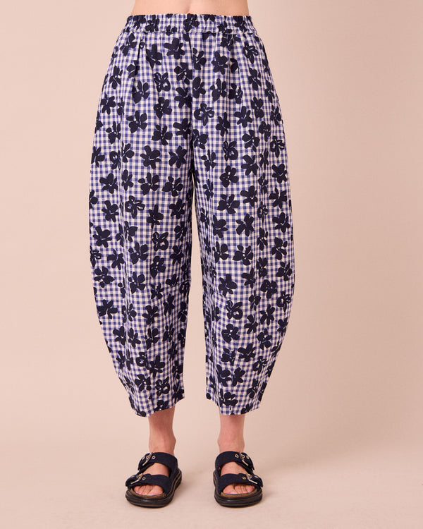 model wears daisy floral stamped gingham linen trousers front