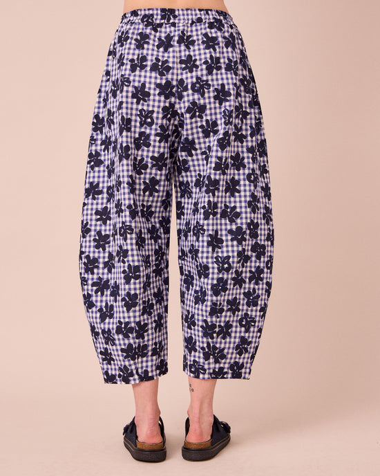 model wears daisy floral stamped gingham linen trousers back