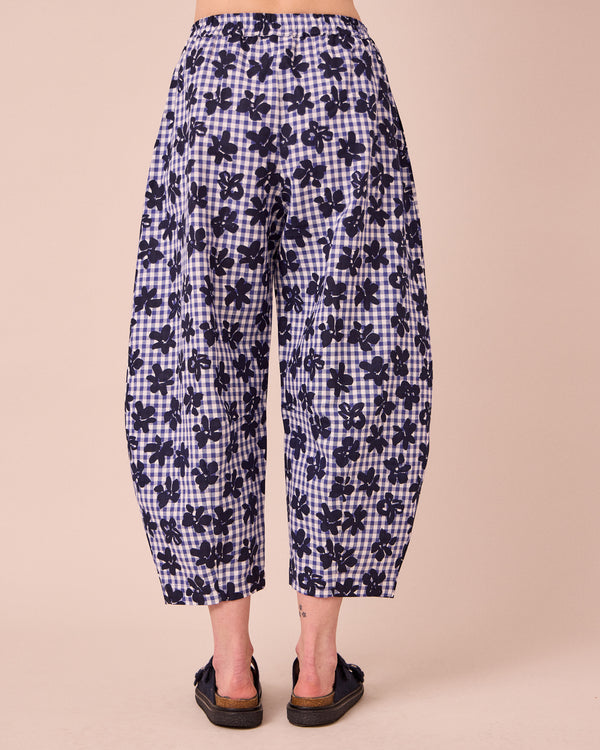 model wears daisy floral stamped gingham linen trousers back