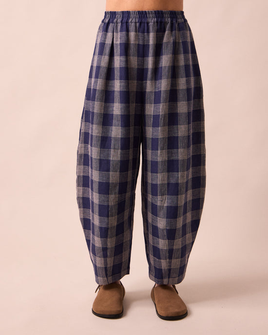 model wears daisy navy plaid linen trousers front