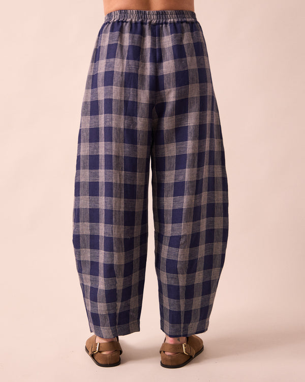model wears daisy navy plaid linen trousers back