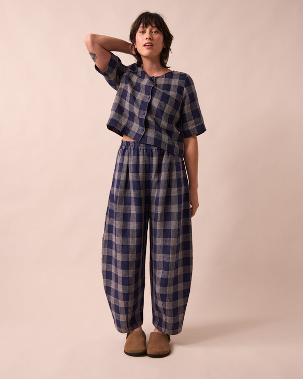 model wears daisy navy plaid linen trousers front