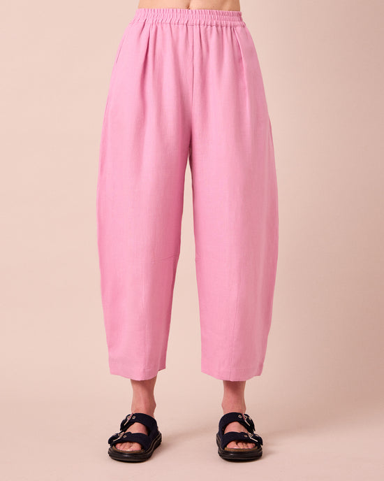 model wears daisy rose pink linen trousers front