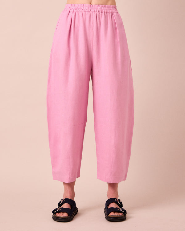 model wears daisy rose pink linen trousers front