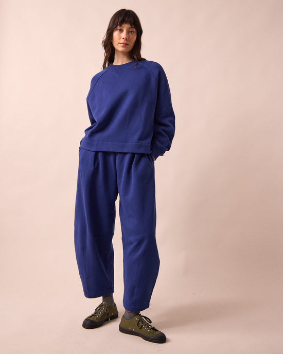 model wears daisy french blue fleeceback jersey trousers left