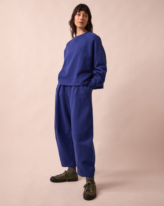 model wears daisy french blue fleeceback jersey trousers left