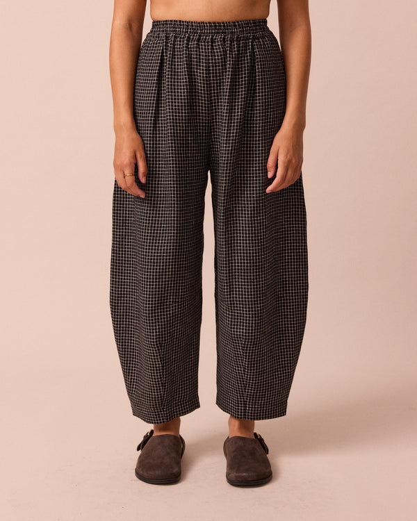 model wears daisy black mini grid linen trousers