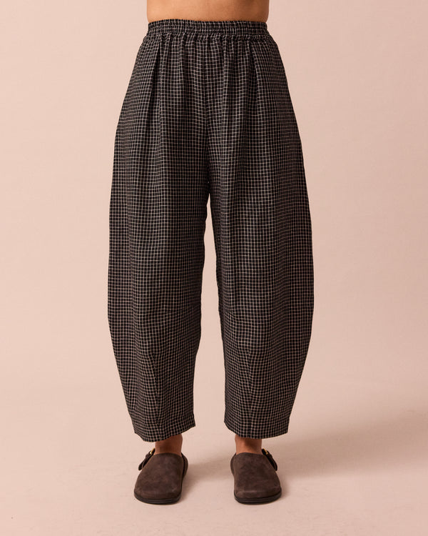 model wears daisy black mini grid linen trousers front